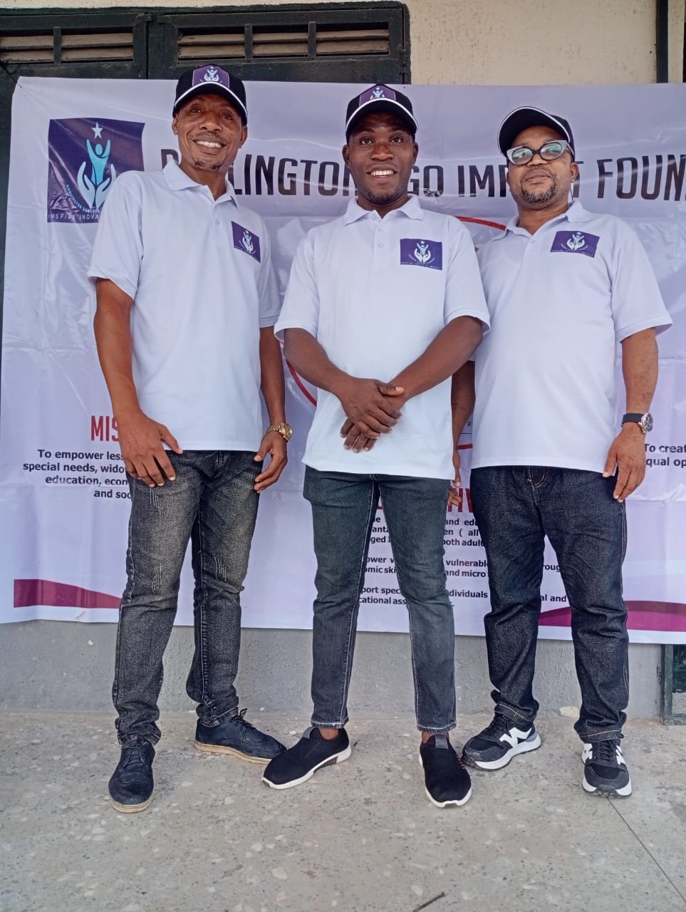 Ugo Impact Foundation team in front of the Foundation banner